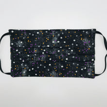 Load image into Gallery viewer, Made with three layers of small white, gold and purple dots on black print 100% quilting cotton, this mask includes a filter pocket located in the pleats in the back of the mask for a filter of your choice, adjustable elastic ear loops and a bendable aluminum nose. Machine wash and dry after each use. 7” H x 7.5” W