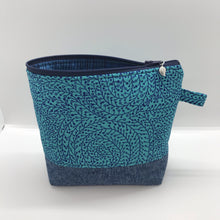 Load image into Gallery viewer, The pouch is made from 100% quilting cotton with a blue/teal vine maze print, Kaufman Essex cotton/linen for the base, and a layer of fleece. The cute metal tassel gives an added touch. 7.5 W x 6”H x 2.5”D. Machine washable and dryer safe, or air dry.