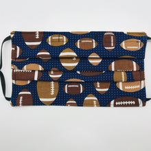 Load image into Gallery viewer, Made with three layers of footballs on blue print 100% quilting cotton, this mask includes a filter pocket located in the pleats in the back of the mask for a filter of your choice, adjustable elastic ear loops and a bendable aluminum nose. Machine wash and dry after each use. 7” H x 7.5” W