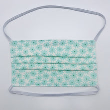 Load image into Gallery viewer, Masks are made of 2 layers of aqua flowers on white print 100% quilting cotton and have behind the head elastic bands. The masks also have a bendable aluminum nose. Wash in washing machine and dry in dryer after each use. 7” H x 7.5” W