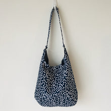 Load image into Gallery viewer, This beautiful 100% quilting cotton of a white dots on blue print makes a great tote bag that is light and durable. The lining is beautiful Essex cotton\linen from Robert Kaufman and has a magnetic snap and inner pocket. 15.5” W & 14”H. Total length with strap 33”