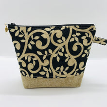 Load image into Gallery viewer, The pouch is made from 100% quilting cotton with a gold swirls on black print, Kaufman Essex cotton/linen for the base, and a layer of fleece. The cute metal tassel gives an added touch. 7.5 W x 6”H x 2.5”D. Machine washable and dryer safe, or air dry.