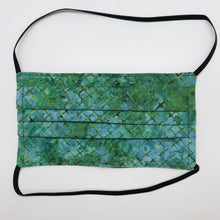 Load image into Gallery viewer, Made with three layers of blue and green batik 100% quilting cotton, this mask includes a filter pocket located in the pleats in the back of the mask for a filter of your choice, elastic head bands and a bendable aluminum nose. Machine wash and dry after each use. 7” H x 7.5” W