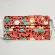 Load image into Gallery viewer, Face masks are made of 100% quilting-weight cotton of flowers on an orange background print. The masks have adjustable ear loops and a bendable aluminum nose piece. Machine wash and dry after each use. 7" H x 7.5" W