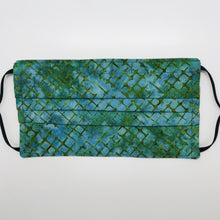 Load image into Gallery viewer, Made with three layers blue and green batik 100% quilting cotton, this mask includes a filter pocket located in the pleats in the back of the mask for a filter of your choice, adjustable elastic ear loops and a bendable aluminum nose. Machine wash and dry after each use. 7” H x 7.5” W