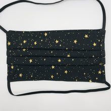 Load image into Gallery viewer, Made with three layers of 100% quilting-weigh cotton Rifle Paper Co Metallic Stars printed fabric and includes a filter pocket located in the pleats in the back of the mask for a filter of your choice. This face mask has elastic head bands and a bendable aluminum nose piece. Machine wash and dry after each use. 7” H x 7.5” W