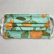 Load image into Gallery viewer, Masks are made of 2 layers of peaches on a blue/green background print 100% quilting-weight cotton, elastic adjustable ear loops and a bendable aluminum nose piece. Machine wash and dry after each use. 7” H x 7.5” W