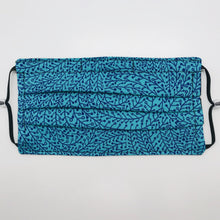 Load image into Gallery viewer, Masks are made of 2 layers of 100% quilting-weight blue/teal swirl print cotton fabric. The mask has elastic adjustable ear loops and a bendable aluminum nose piece. Machine wash and dry after each use. 7” H x 7.5” W