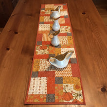 Load image into Gallery viewer, Beautiful fall colors table runner. 100% cotton, disappearing nine patch design. free-motion quilted in circular design. machine wash cold, line dry. 44" L x 11.5" W