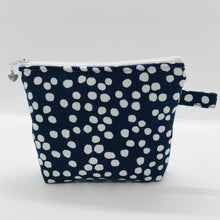Load image into Gallery viewer, The pouch is made of 100% quilting cotton of a white dots on blue print and a layer of fleece for stability. The cute metal tassel gives an added touch. 6”W x 4.5” H x 1”D. Machine washable and dryer safe, or air dry.