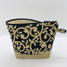 Load image into Gallery viewer, The pouch is made from 100% quilting cotton with a gold swirls on black print, Kaufman Essex cotton/linen for the base, and a layer of fleece. The cute metal tassel gives an added touch. 7.5 W x 6”H x 2.5”D. Machine washable and dryer safe, or air dry.