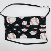 Load image into Gallery viewer, Made with three layers of baseballs on black print 100% quilting cotton, this mask includes a filter pocket located in the pleats in the back of the mask for a filter of your choice, elastic head bands and a bendable aluminum nose. Machine wash and dry after each use. 7” H x 7.5” W