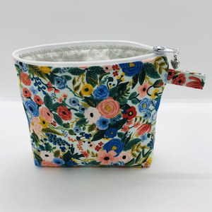 The pouch is made of 100% quilting cotton from Rifle Paper Co and features a multicolored woodland floral print and a layer of fleece for stability. The cute metal tassel gives an added touch. 6”W x 4.5” H x 1”D. Machine washable and dryer safe, or air dry.