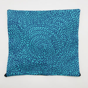 Image of black swirl vines on blue cotton print.