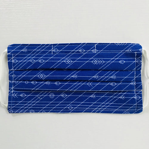 100% quilting-weight cotton face mask with adjustable elastic ear loops and bendable nose piece. Washable, reusable fabric face mask. Wash in washing machine and dry in dryer after each use. 7” H x 7.5” W  This fun cobalt blue fabric with white lines and arrows in from the designer Alison Glass by  Andover Fabrics