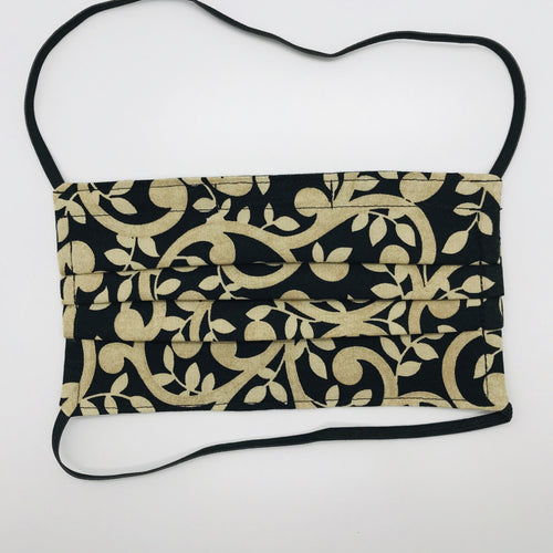 Masks are made of 2 layers 100% quilting cotton featuring a gold swirls on black print, over the head elastic loops and a bendable aluminum nose. Wash in washing machine and dry in dryer after each use. 7” H x 7.5” W.  