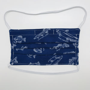 Masks are made of 2 layers 100% quilting cotton featuring a print of white fish on a blue background, over the head elastic loops and a bendable aluminum nose. Wash in washing machine and dry in dryer after each use. 7” H x 7.5” W 