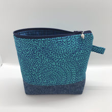 Load image into Gallery viewer, The pouch is made from 100% quilting cotton with a blue/teal vine maze print, Kaufman Essex cotton/linen for the base, and a layer of fleece. The cute metal tassel gives an added touch. 7.5 W x 6”H x 2.5”D. Machine washable and dryer safe, or air dry.
