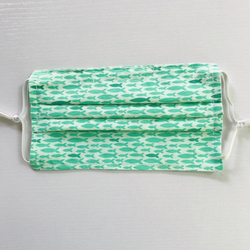 100% quilting-weight aqua green sea life print cotton face mask with adjustable elastic ear loops and bendable nose piece. Washable, reusable fabric face mask. Wash in washing machine and dry in dryer after each use. 7” H x 7.5” W  Fabric Collection: Reef by Elizabeth Hartman from Robert Kaufman