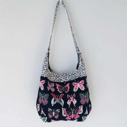 Light weight and roomy this tote is made of soft and smooth Art Gallery butterfly print cotton, and lined with Essex cotton/linen from Robert Kaufman. The inner compartment has a magnetic snap and inner pocket. 15.5” W & 14”H Total length with strap 33