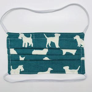 Made with three layers of white dogs on green print 100% quilting cotton, this mask includes a filter pocket located in the pleats in the back of the mask for a filter of your choice, elastic head bands and a bendable aluminum nose. Machine wash and dry after each use. 7” H x 7.5” W