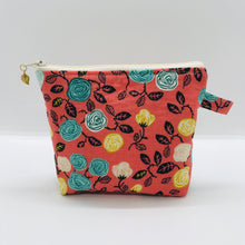 Load image into Gallery viewer, The pouch is made from 100% cotton flowers on orange print and has a layer of fleece for structure and a cute metal tassel. The pouch design is from the Becca Bags pattern from Lazy Girl Design.  6”W x 4.5” H x 1”D. Machine washable and dryer safe or air dry.
