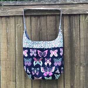 Light weight and roomy this tote is made of soft and smooth Art Gallery butterfly print cotton, and lined with Essex cotton/linen from Robert Kaufman. The inner compartment has a magnetic snap and inner pocket. 15.5” W & 14”H Total length with strap 33"