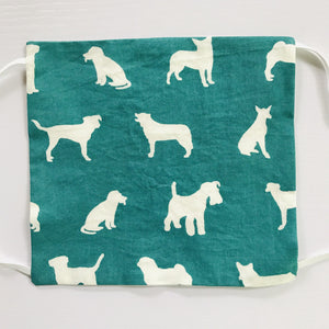 100%  quilting-weight green with white dogs themed cotton face mask with elastic bands and bendable nose piece. Washable, reusable fabric face mask. Wash in washing machine and dry in dryer after each use. 7” H x 7.5” W