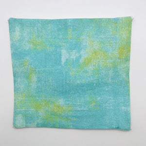 Green, white and yellow textured cotton print image.