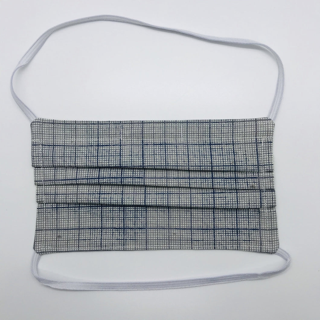 Masks are made of 2 layers 100% quilting cotton featuring a blue and white graph print, behind the head elastic band and a bendable aluminum nose. Wash in washing machine and dry in dryer after each use. 7” H x 7.5” W