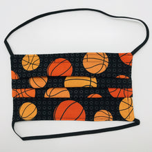 Load image into Gallery viewer, Made with three layers of basketballs on black print 100% quilting cotton, this mask includes a filter pocket located in the pleats in the back of the mask for a filter of your choice, elastic head bands and a bendable aluminum nose. Machine wash and dry after each use. 7” H x 7.5” W
