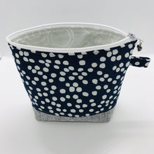 Load image into Gallery viewer, The pouch is made from 100% quilting cotton with a white dots on blue print, Kaufman Essex cotton/linen for the base, and a layer of fleece. The cute metal tassel gives an added touch. 7.5 W x 6”H x 2.5”D. Machine washable and dryer safe, or air dry.
