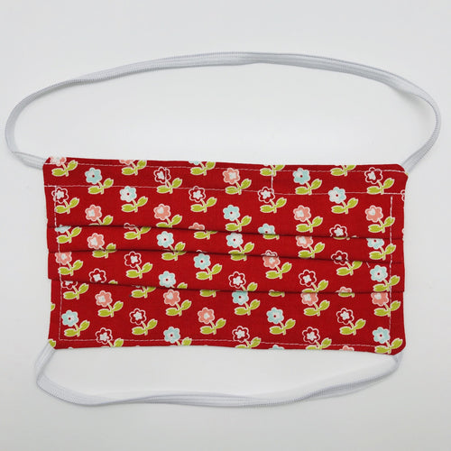 Masks are made of 2 layers of 100% quilting-weight cotton with a vintage picnic flowers on red print  and have behind the head elastic bands. The masks also have a bendable aluminum nose piece which helps to make a better seal over the wearers face. Wash in washing machine and dry in dryer after each use. 7” H x 7.5” W