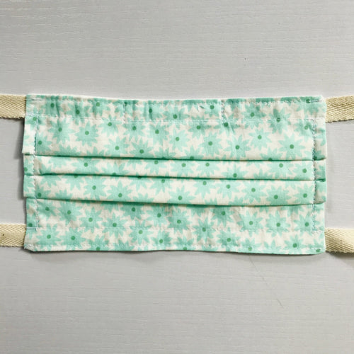 100% quilting-weight aqua green cotton face mask with twill tape straps and bendable nose piece. Washable, reusable fabric face mask. Wash in washing machine and dry in dryer after each use.  Fabric from the Pond collection by Elizabeth Hartman  7” H x 7.5” W
