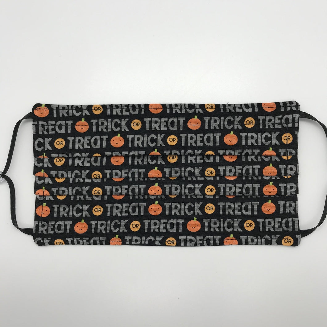 Masks are made of 2 layers 100% quilting cotton featuring a print of trick or treat words and pumpkins  on black, adjustable elastic ear loops and a bendable aluminum nose. Wash in washing machine and dry in dryer after each use. 7” H x 7.5” W