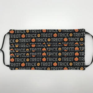 Made with three layers of trick or treat words on orange pumpkins on black print 100% quilting cotton, this mask includes a filter pocket located in the pleats in the back of the mask for a filter of your choice, adjustable elastic ear loops and a bendable aluminum nose. Machine wash and dry after each use. 7” H x 7.5” W