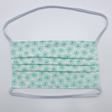 Load image into Gallery viewer, Masks are made of 2 layers of aqua flowers on white print 100% quilting cotton and have behind the head elastic bands. The masks also have a bendable aluminum nose. Wash in washing machine and dry in dryer after each use. 7” H x 7.5” W
