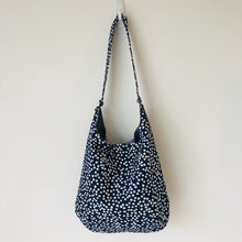 Load image into Gallery viewer, This beautiful 100% quilting cotton of a white dots on blue print makes a great tote bag that is light and durable. The lining is beautiful Essex cotton\linen from Robert Kaufman and has a magnetic snap and inner pocket. 15.5” W &amp; 14”H. Total length with strap 33”
