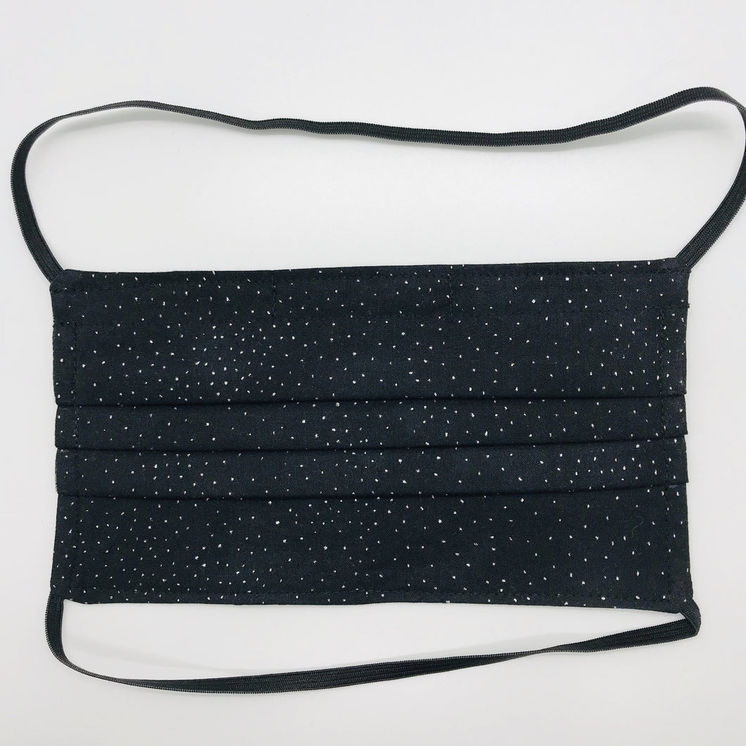 Masks are made of 2 layers 100% quilting cotton featuring a metallic silver sparkle on black print, over the head elastic loops and a bendable aluminum nose. Wash in washing machine and dry in dryer after each use. 7” H x 7.5” W