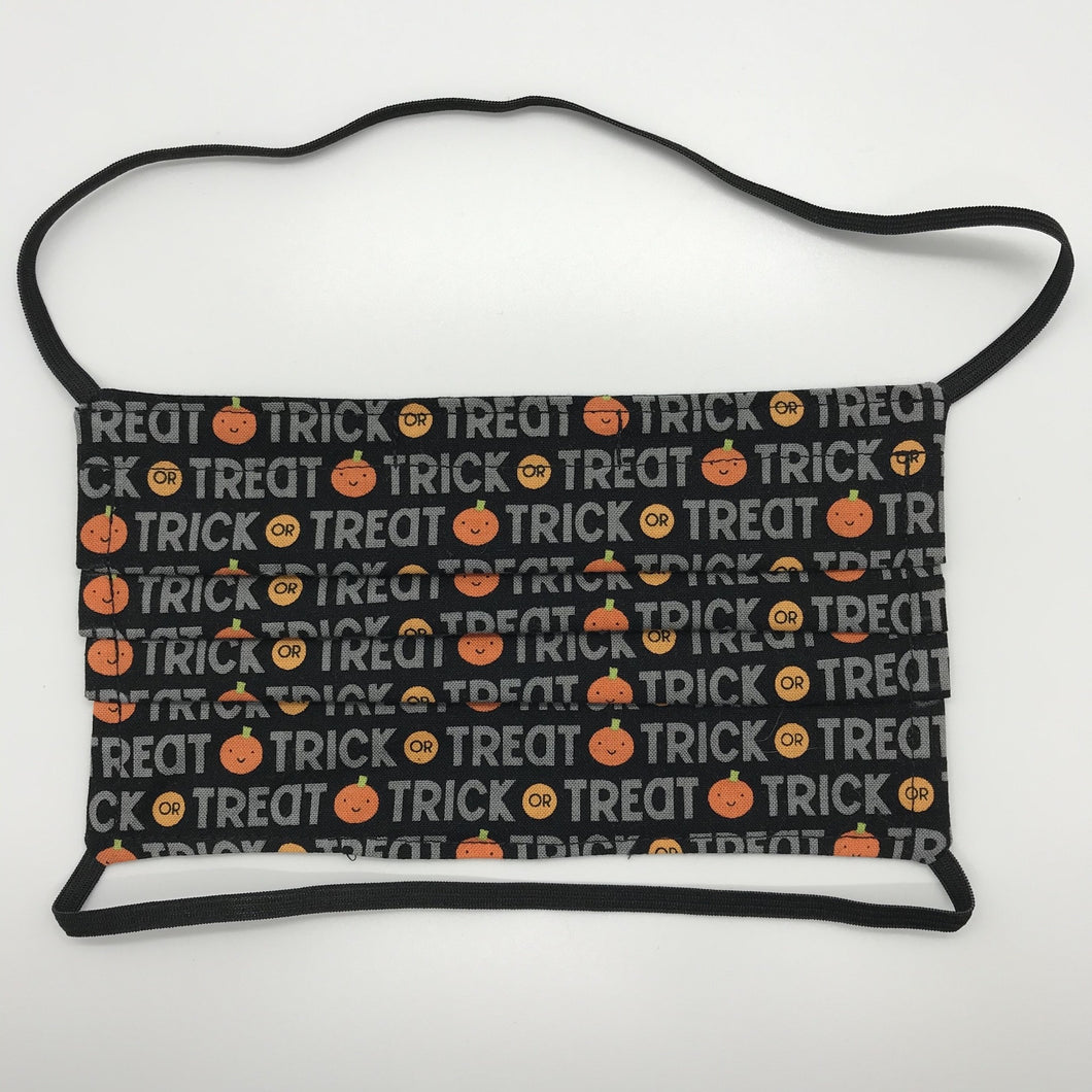 Masks are made of 2 layers 100% quilting cotton featuring a print of trick or treat words on black, over the head elastic loops and a bendable aluminum nose. Wash in washing machine and dry in dryer after each use. 7” H x 7.5” W 