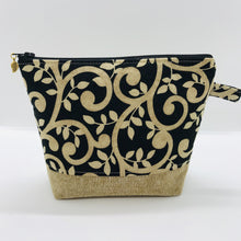 Load image into Gallery viewer, The pouch is made from 100% quilting cotton with a gold swirls on black print, Kaufman Essex cotton/linen for the base, and a layer of fleece. The cute metal tassel gives an added touch. 7.5 W x 6”H x 2.5”D. Machine washable and dryer safe, or air dry.

