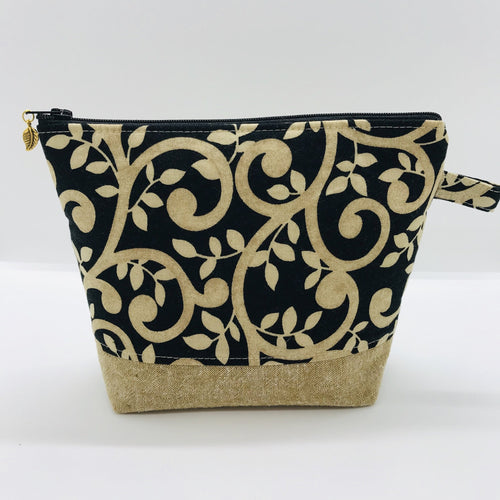 The pouch is made from 100% quilting cotton with a gold swirls on black print, Kaufman Essex cotton/linen for the base, and a layer of fleece. The cute metal tassel gives an added touch. 7.5 W x 6”H x 2.5”D. Machine washable and dryer safe, or air dry.