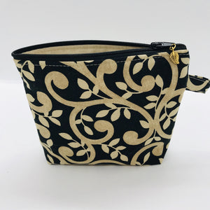 The small pouch is made from 100% gold swirls on black print and has a layer of fleece for structure and a cute metal tassel. The pouch design is from the Becca Bags pattern from Lazy Girl Design. 6”W x 4.5” H x 1”D. Machine washable and dryer safe or air dry.