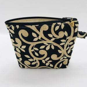The small pouch is made from 100% gold swirls on black print and has a layer of fleece for structure and a cute metal tassel. The pouch design is from the Becca Bags pattern from Lazy Girl Design. 6”W x 4.5” H x 1”D. Machine washable and dryer safe or air dry.