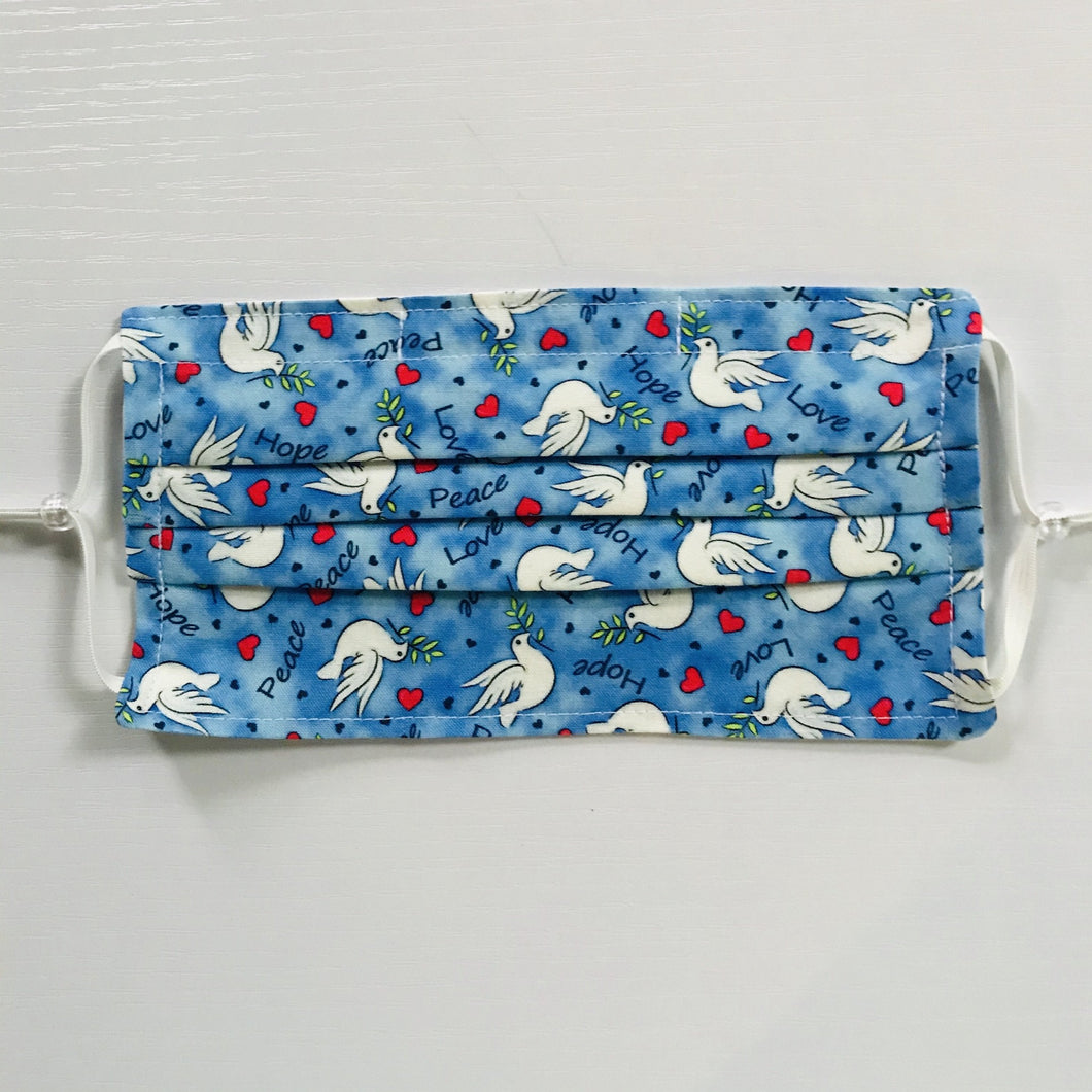 100% quilting-weight cotton, blue with white doves print fabric face mask with adjustable elastic ear loops and bendable nose piece. Washable, reusable fabric face mask. Wash in washing machine and dry in dryer after each use. 7” H x 7.5” 
