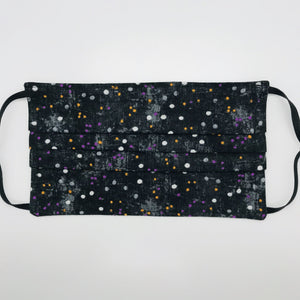 Masks are made of 2 layers 100% quilting cotton featuring a print of small white, gold, and purple dots on black, adjustable elastic ear loops and a bendable aluminum nose. Wash in washing machine and dry in dryer after each use. 7” H x 7.5” W