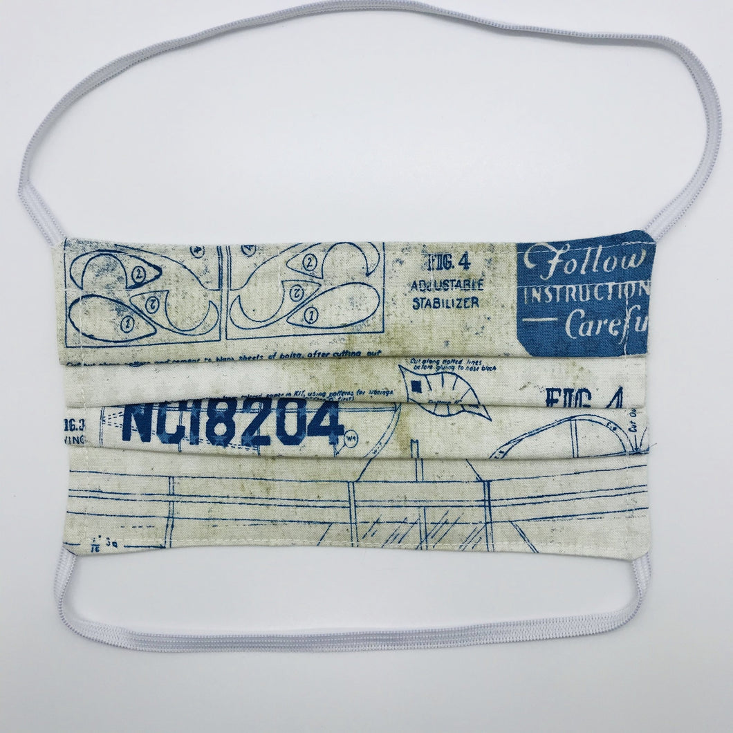 Masks are made of 2 layers 100% quilting cotton featuring a blue and white novelty airplane themed print, behind the head elastic band and a bendable aluminum nose. Wash in washing machine and dry in dryer after each use. 7” H x 7.5” W