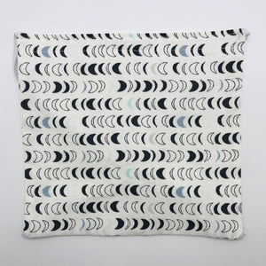 Image of black, white and blue half moons in on a white background cotton print. Made by Art Gallery Fabrics know for lightweight soft and smooth cotton.