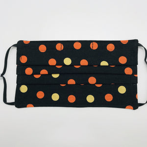 Made with three layers of orange and gold dots on black print 100% quilting cotton, this mask includes a filter pocket located in the pleats in the back of the mask for a filter of your choice, adjustable elastic ear loops and a bendable aluminum nose. Machine wash and dry after each use. 7” H x 7.5” W