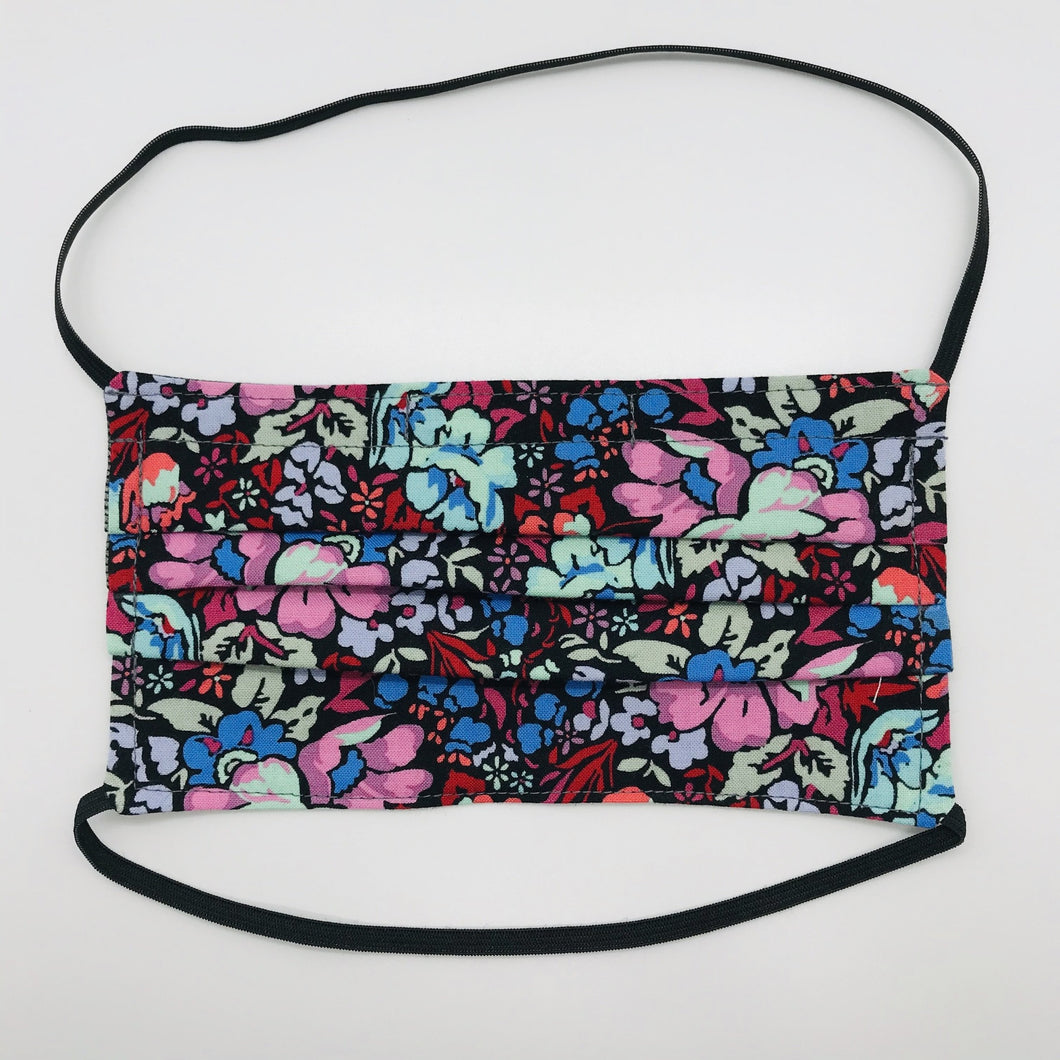Masks are made of 2 layers of burgundy, pink and blue floral print 100% quilting cotton and have behind the head elastic bands. The masks also have a bendable aluminum nose. Wash in washing machine and dry in dryer after each use. 7” H x 7.5” W